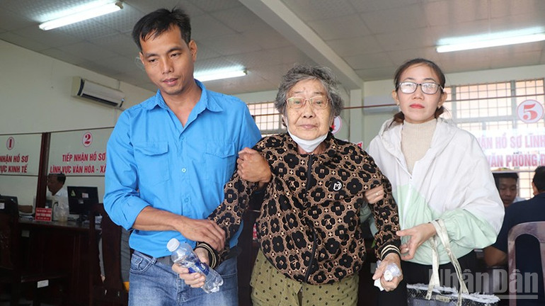 Đội hình bình dân học vụ số hỗ trợ người già khi đến Trung tâm phục vụ hành chính công. ndo_br_8.jpg