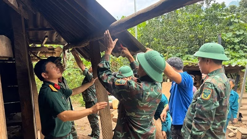 Cán bộ, chiến sĩ Ban Chỉ huy phòng phủ khu vực 4 Mường Ảng và cán bộ, công chức xã Pú Nhung giúp nhân dân tháo dỡ, di chuyển nhà cửa tránh nguy cơ sạt lở nghiêm trọng.