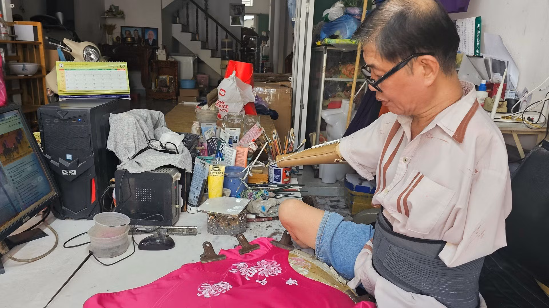 Họa sĩ Hùng Bảo vẽ tác phẩm lên áo dài.