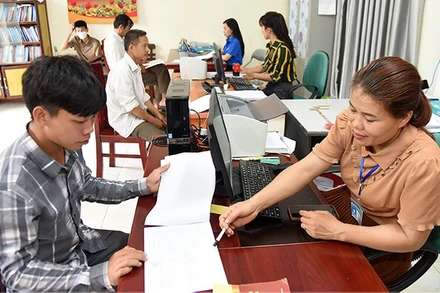 Cán bộ xã Kiên Mộc (huyện Đình Lập, tỉnh Lạng Sơn) hướng dẫn người dân làm các thủ tục hành chính. (Ảnh: KHÁNH AN) 