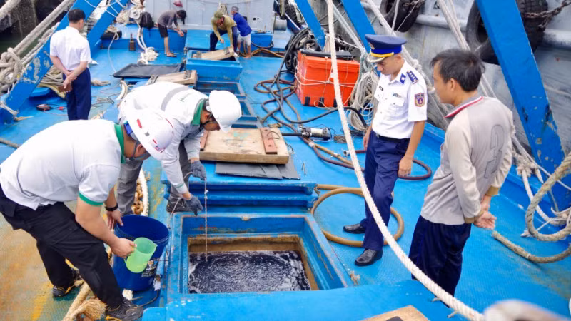 Tổ giám định tiến hành kiểm tra dầu trong khoang tàu. (Ảnh: Bộ Tư lệnh Vùng Cảnh sát biển 3)