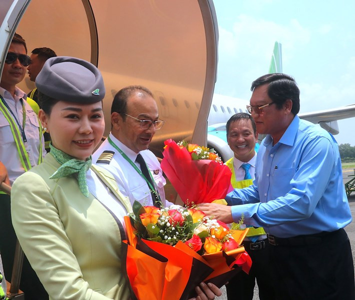 Phó chủ tịch Ủy ban nhân dân tỉnh Cà Mau Lâm Văn Bi (bìa phải) tặng hoa chúc mừng đáp thành công chuyến bay kỹ thuật.