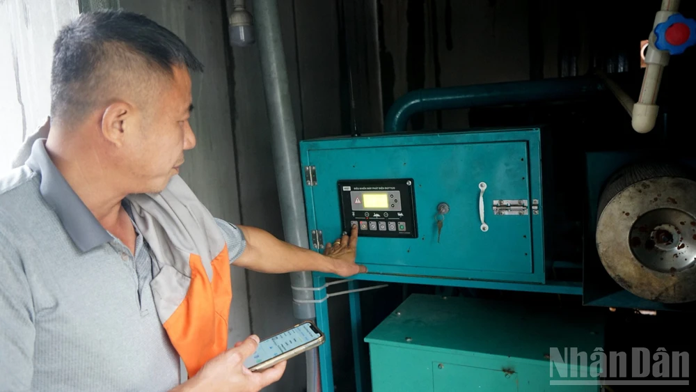 Ông Trần Xuân Phong vận hành máy phát điện từ khí biogas. (Ảnh: TRUNG HƯNG)