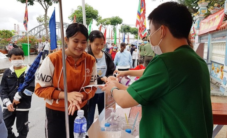 Phát khẩu trang y tế cho người dân đến tham dự lễ hội. Lễ hội Anh hùng dân tộc Nguyễn Trung Trực ở Kiên Giang -0
