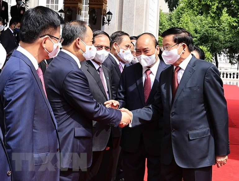 Tổng Bí thư, Chủ tịch nước Lào đón, hội đàm với Chủ tịch nước Nguyễn Xuân Phúc -0