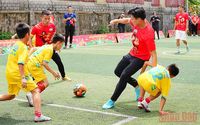 Cầu thủ Quế Ngọc Hải (áo đỏ bên phải) chơi bóng đá cùng học sinh Trường Tiểu học Nguyễn Trãi (thành phố Vinh). Trao máy tính bảng và hàng nghìn phần quà tặng thiếu nhi Nghệ An -0