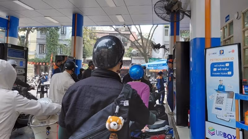 Người dân xếp hàng mua xăng tại cửa hàng trên phố Trần Hưng Đạo (Hà Nội). 