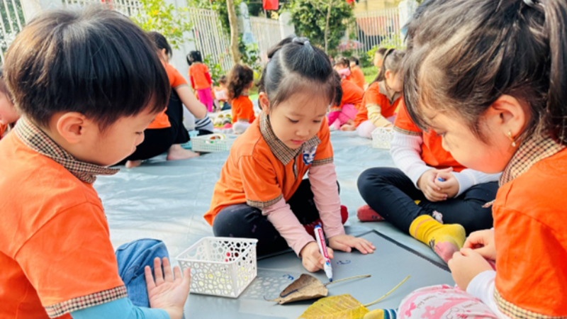 Các bạn nhỏ trong giờ hoạt động tạo hình con vật từ lá cây tại Trường mầm non Tuổi thơ (quận Hoàng Mai). 
