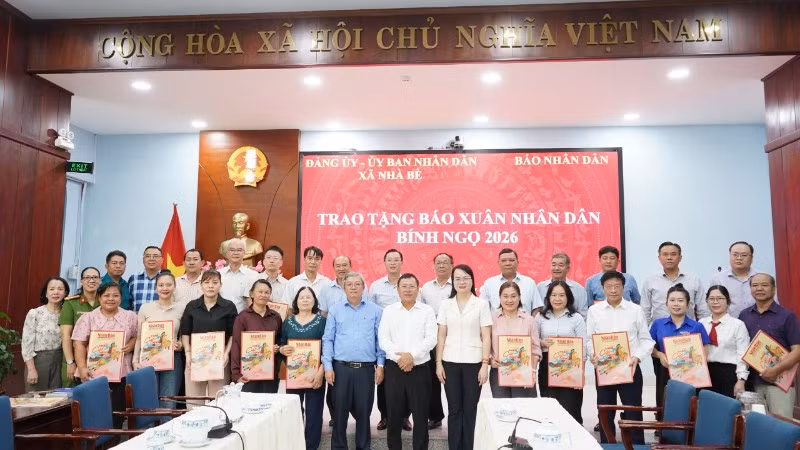 Cơ quan Đại diện Báo Nhân Dân tại khu vực miền Nam cùng Hội đồng nhân dân, Ủy ban nhân dân xã Nhà Bè trao tặng báo Xuân Nhân Dân Bính Ngọ 2026 tại xã Nhà Bè. (Ảnh: KIM NGỌC)