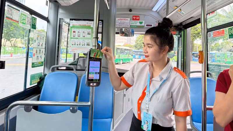 Nhân viên phục vụ hướng dẫn hành khách cài đặt ứng dụng MultiGo và các phương thức thanh toán điện tử. Tuy nhiên, trong thời gian từ ngày 1/7 đến cuối tháng 9 thành phố chưa kiểm tra các giấy tờ tùy thân. (Ảnh: QUÝ HIỀN)