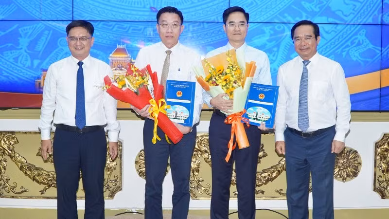 Ông Trần Quang Lâm nhận quyết định làm Giám đốc Sở Xây dựng Thành phố Hồ Chí Minh và ông Nguyễn Anh Minh (thứ hai từ trái qua) nhận quyết định làm Giám đốc Ban Quản lý dự án đầu tư xây dựng các công trình giao thông Thành phố Hồ Chí Minh 