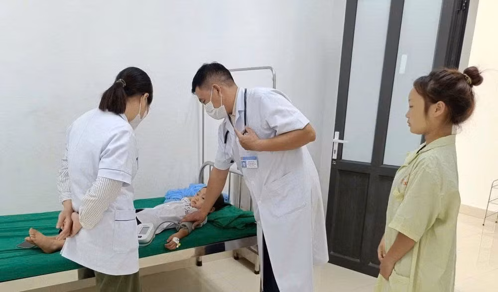 Bác sĩ ở Trung tâm Y tế Nậm Pồ khám, điều trị cho trẻ mắc bệnh quai bị. (Ảnh: LÊ LAN)