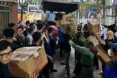 Bốc xếp hàng hóa thiết yếu lên xe để hỗ trợ bà con bị ảnh hưởng bão lũ ở tỉnh Đắk Lắk.