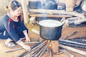  Chị Y Hoa tất bật nấu rượu nếp cẩm men lá.