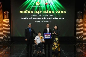 Thứ trưởng Giáo dục Ngô Thị Minh và Chủ tịch Công đoàn Giáo dục Việt Nam Nguyễn Ngọc Ân trao giải đặc biệt tặng em Nguyễn Minh Kiệt, Trường Trung học cơ sở Chương Dương, Hoàn Kiếm, Hà Nội và thầy giáo của mình.