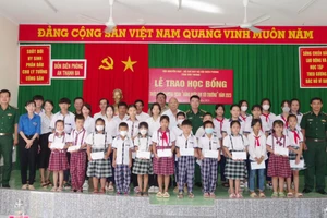 Đại diện lãnh đạo Bộ đội Biên phòng tỉnh và Hội Khuyến học tỉnh Sóc Trăng trao học bổng cho các em học sinh. 
