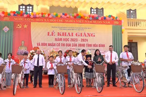 Đồng chí Bùi Thị Minh Hoài cùng lãnh đạo tỉnh Hòa Bình tặng xe đạp cho học sinh tại buổi Lễ khai giảng năm học mới.