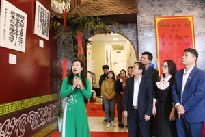 Các đại biểu tham quan trưng bày cổ vật, hiện vật tiêu biểu thời Lý-Trần. Ảnh: THU THỦY