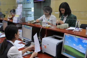 Tỷ giá chưa có biến động quá mạnh sau quyết định tăng lãi suất của FED. Ảnh: NAM ANH