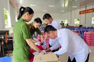 Cán bộ Trại giam Kênh 7 làm thủ tục cho người được đặc xá trước khi trở về tái hoà nhập cộng đồng. (Ảnh: VĂN VŨ)