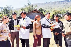 Bác sĩ cùng nhân viên y tế thôn, bản tuyên truyền kiến thức về sức khỏe sinh sản tới đồng bào dân tộc vùng biên giới Lào Cai. Ảnh: TTXVN