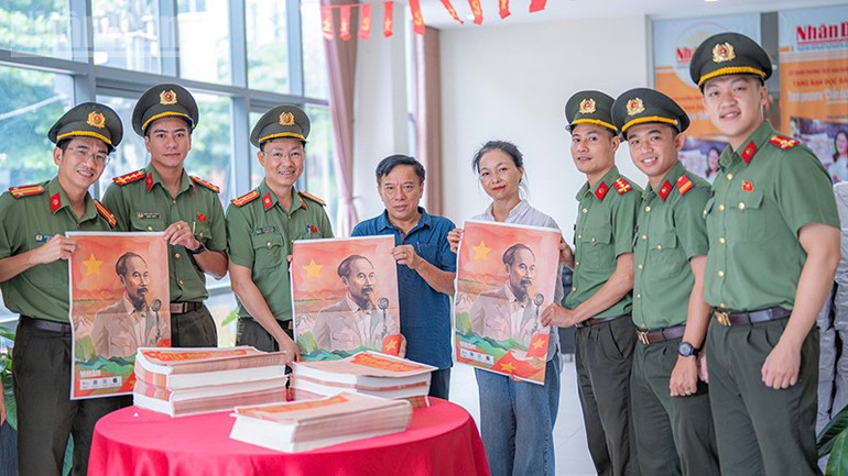 Đại diện Báo Nhân Dân tại miền trung-Tây Nguyên trao tặng ấn phẩm cho Công an thành phố Đà Nẵng. ndo_tl_4.jpg