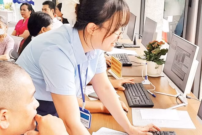 Cán bộ Điểm phục vụ Hành chính công phường Tây Hồ hướng dẫn người dân làm thủ tục hành chính trên môi trường mạng. 