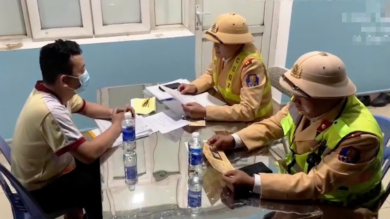 Cảnh sát giao thông làm việc với người vi phạm trật tự an toàn giao thông.