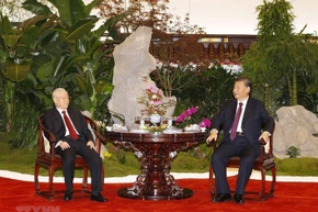 Tổng Bí thư Nguyễn Phú Trọng và Tổng Bí thư, Chủ tịch Trung Quốc Tập Cận Bình thưởng thức trà. (Ảnh: Trí Dũng/TTXVN)