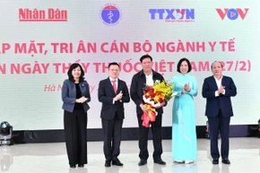 Tổng Biên tập Báo Nhân Dân Lê Quốc Minh và lãnh đạo các cơ quan báo chí chủ lực tặng hoa cho Thứ trưởng Thường trực Bộ Y tế Đỗ Xuân Tuyên nhân Ngày Thầy thuốc Việt Nam. (Ảnh: ĐĂNG KHOA)