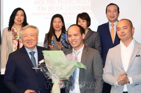 Phó Thủ tướng thường trực Nguyễn Hòa Bình tặng hoa Chủ tịch ViLaB, Phùng Quốc Trí. (Ảnh: TTXVN)