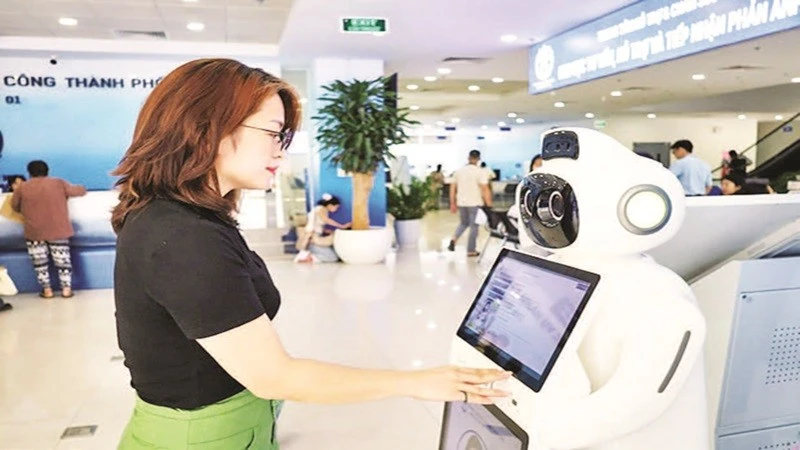 Người dân sử dụng robot AI hỗ trợ, tư vấn thủ tục hành chính tại Trung tâm Phục vụ hành chính công thành phố Hà Nội. (Ảnh LÊ HẢI)