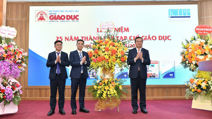 Thứ trưởng Bộ Giáo dục và Đào tạo Nguyễn Văn Phúc (bên phải ảnh) chúc mừng, tặng hoa lãnh đạo Tạp chí Giáo dục. 