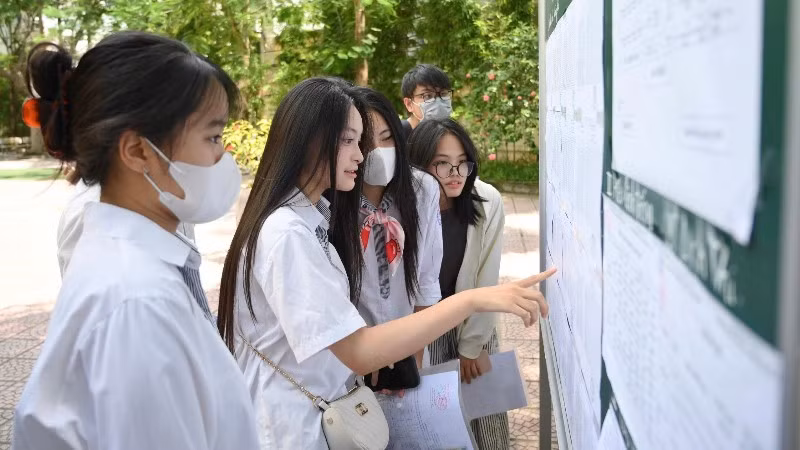 Thí sinh xem thông tin phòng thi tại điểm thi Trường THCS Minh Khai, Hà Nội. (Ảnh: THẾ ĐẠI)