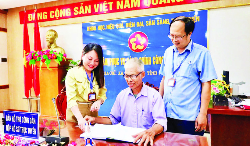 Cán bộ Trung tâm Phục vụ hành chính công xã Tam Nông hỗ trợ người dân thực hiện các thủ tục hành chính.