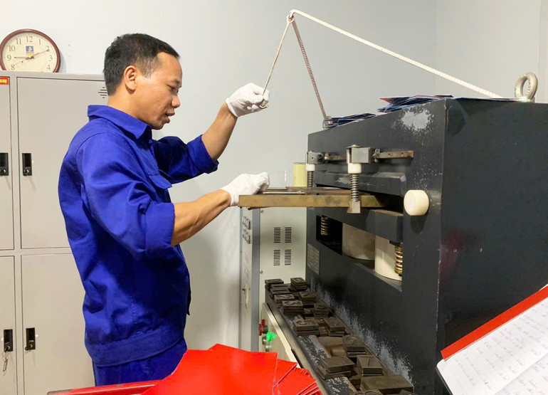 Thao tác trên máy dập biển số. z6963957056896-763b4cbe86bbb8cd02e82a83c4befda3.jpg