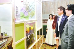 Nhà đầu tư nước ngoài tìm hiểu thông tin về các dự án kêu gọi đầu tư tại buổi gặp gỡ. (Ảnh THẾ ANH)