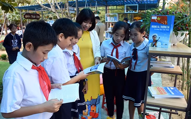 Cô giáo và học sinh Trường tiểu học Lê Văn Hiến, quận Ngũ Hành Sơn đọc sách trong Khu vườn tuổi thơ.