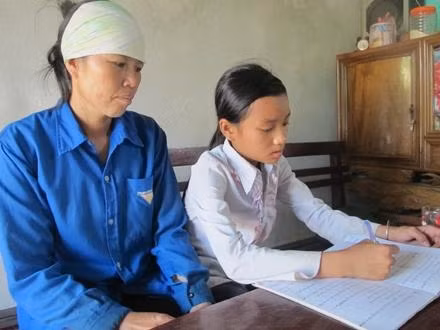 Cháu Nguyễn Thị Lệ dạy mẹ đọc chữ.