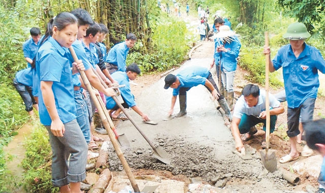 Đoàn viên thanh niên Huyện đoàn Hòa An (Cao Bằng) tham gia làm đường bê-tông tại xã Đức Long. Ảnh: MINH TUYỀN