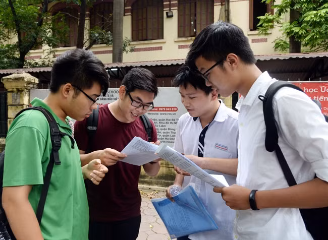 Các thí sinh trao đổi bài thi môn Sinh học (môn cuối trong bài thi tổ hợp KHTN) tại điểm thi Trường THPT Trần Phú (Hà Nội). Ảnh: THỦY MAI