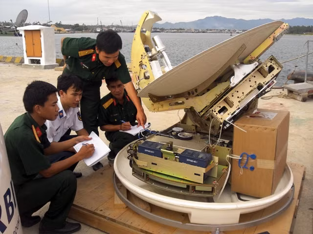 Cán bộ, chiến sĩ Lữ đoàn 132 (Binh chủng Thông tin liên lạc) triển khai lắp đặt thông tin Vinasat trên tàu Hải quân. Ảnh: TUYÊN HUẤN