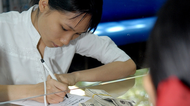 Đồng USD tăng làm tăng áp lực điều chỉnh tỷ giá tương lai của VND. Ảnh: NAM NGUYỄN