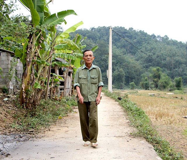 Trưởng thôn Chu Kế Thu trên con đường bê-tông do người dân trong thôn hiến đất làm đường.