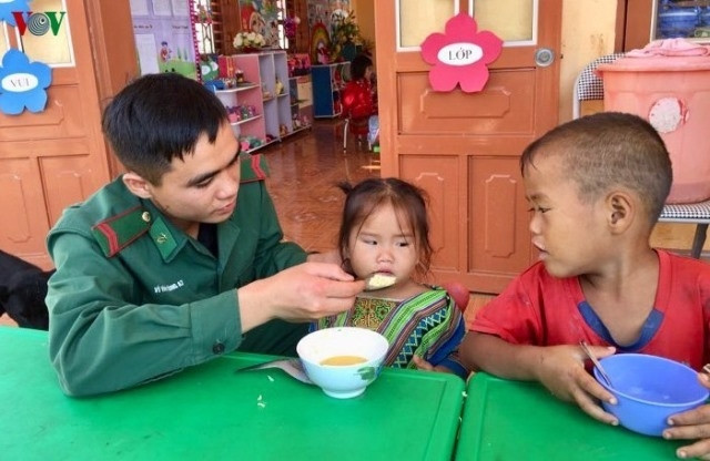 Chiến sĩ Đồn Biên phòng Lóng Sập chăm sóc các cháu học sinh điểm trường Buốc Pát.