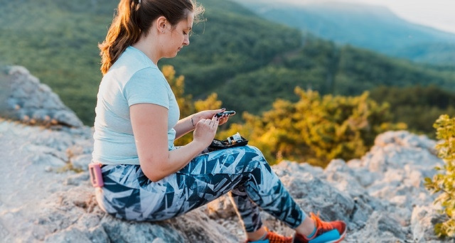 Một người phụ nữ kiểm tra lượng đường trong máu của mình khi đi bộ.