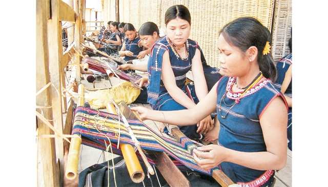 Phụ nữ làng Nghe Nhỏ (thị trấn Kông Chro, huyện Kông Chro, tỉnh Gia Lai) bên khung cửi dệt thổ cẩm truyền thống. Ảnh: HÀ ĐỨC THÀNH