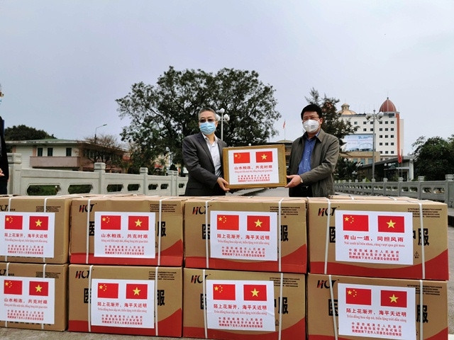Đại diện lãnh đạo TP Phòng Thành Cảng, Quảng Tây (Trung Quốc) trao tặng vật tư y tế cho lãnh đạo TP Hạ Long, Quảng Ninh (Việt Nam).