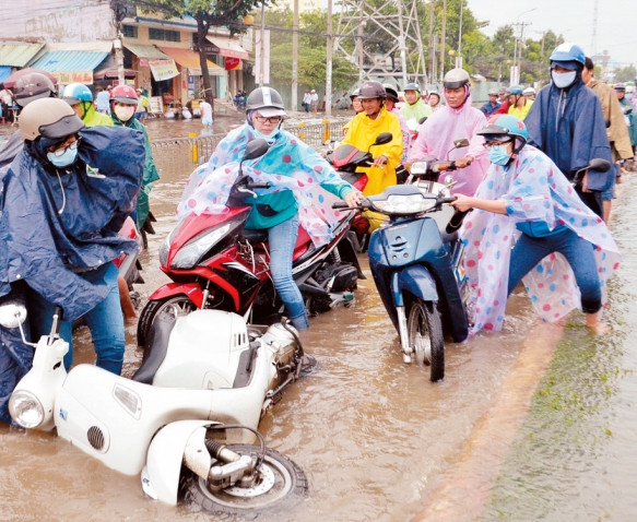 Một khi trời đổ mưa, một số tuyến phố ở TP Hồ Chí Minh lại bị ngập sâu gây khó khăn cho người tham gia giao thông.