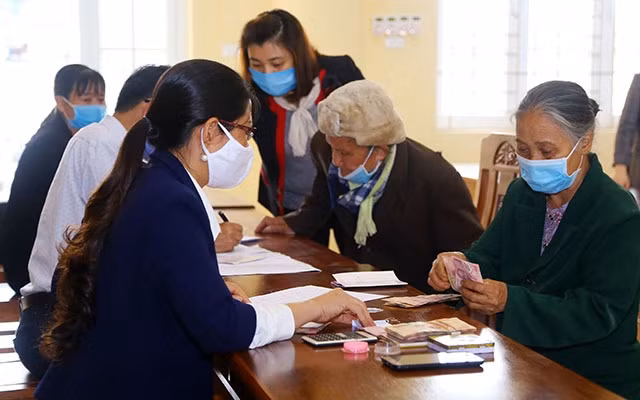 Hộ nghèo ở Hà Nam nhận tiền hỗ trợ của Chính phủ cho người dân gặp khó khăn do dịch Covid-19 (Ảnh: Tống Giáp).